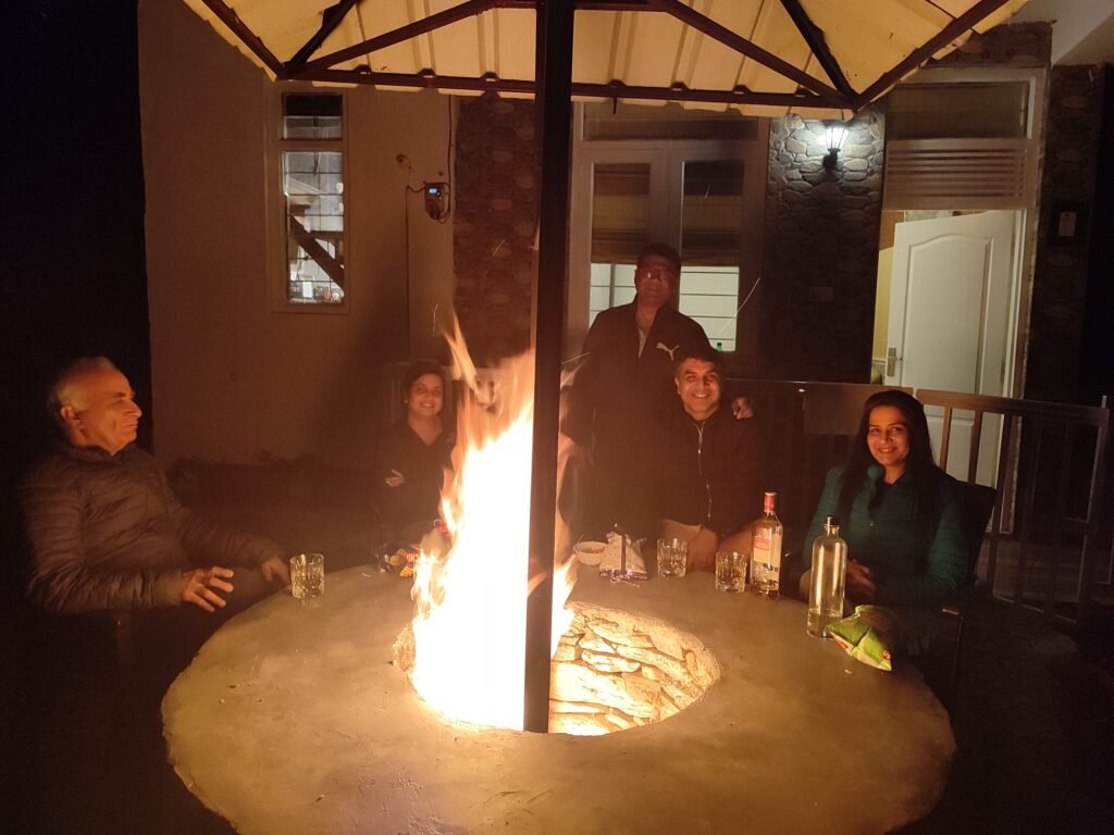 Guests gathered around the fire at dusk